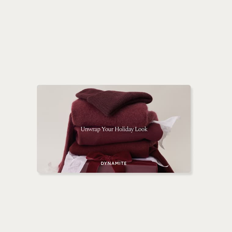 A gift card with an image of a folded pile of burgundy knitwear including a beanie, a cardigan, and a sweater.