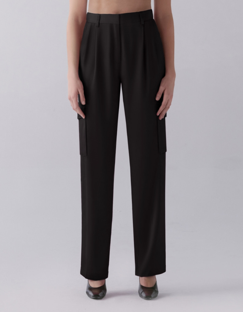 A model wears black satin straight leg pants.