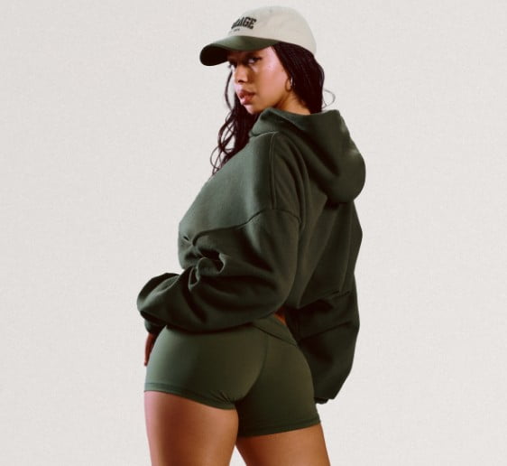 Model wears a light blue hoodie and matching sweats.