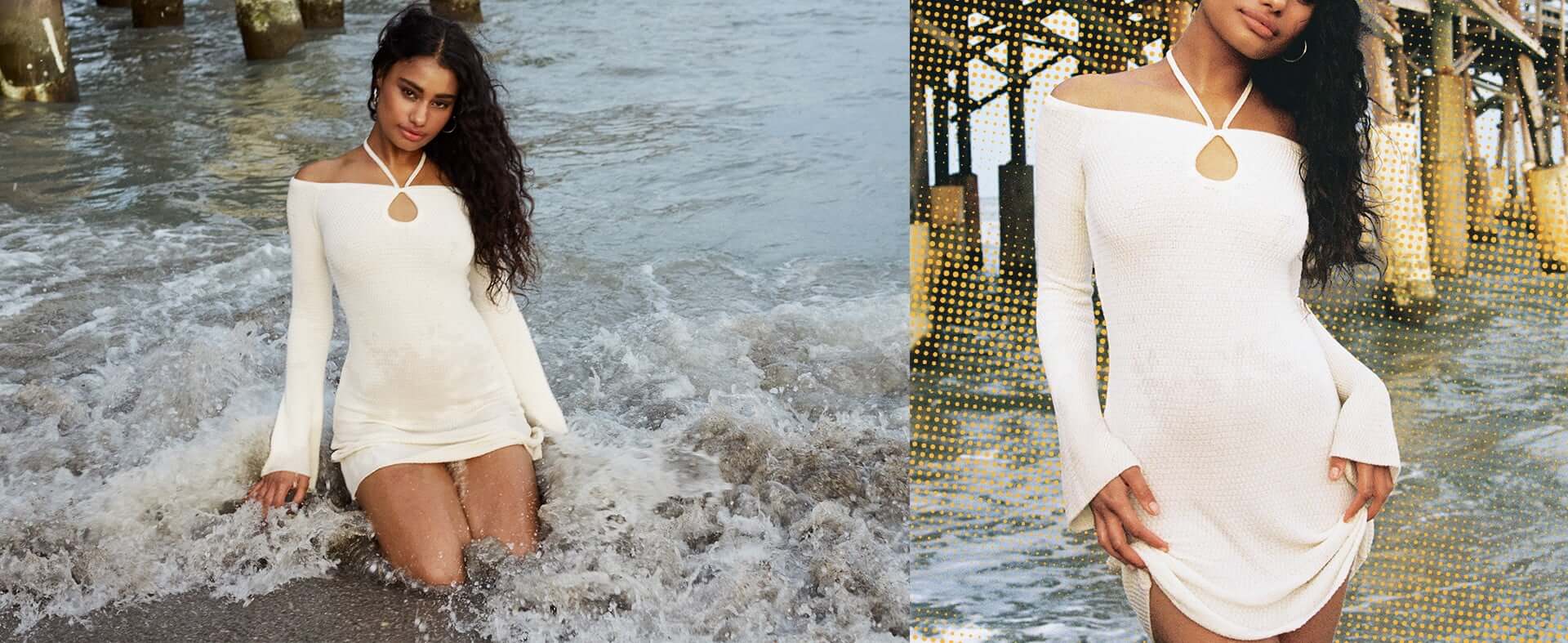 La mannequin prend la pose dans l'eau avec une robe blanche à épaules dégagées.