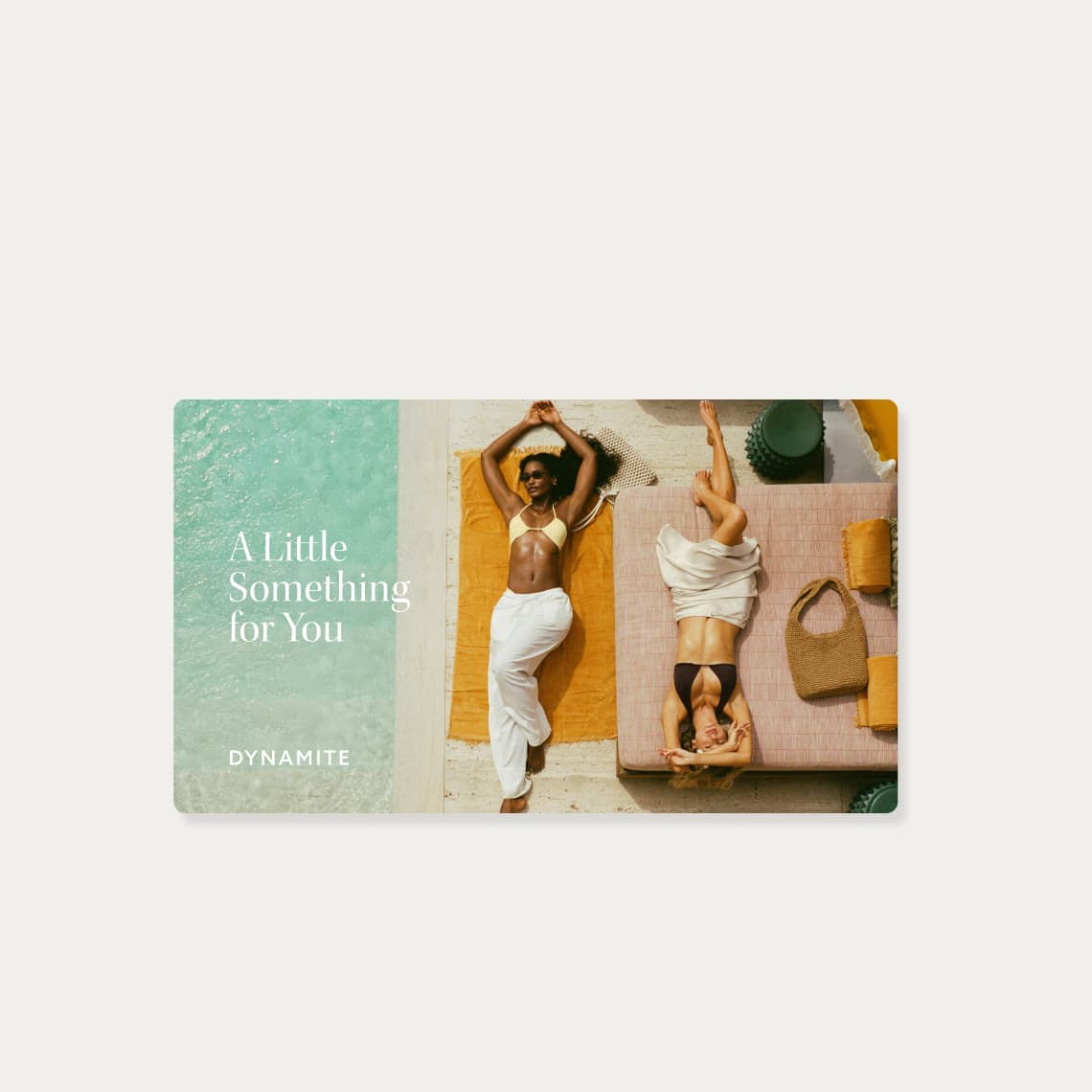 A Dynamite gift card with two models laying by the pool in bikinis.