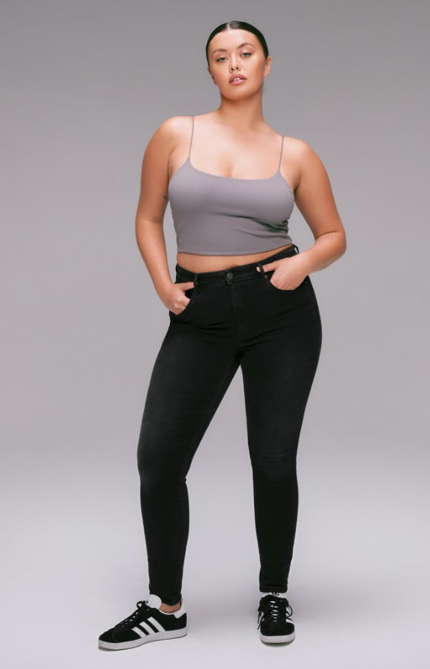 Model is wearing a grey camisole and a black, high rise, skinny jean.