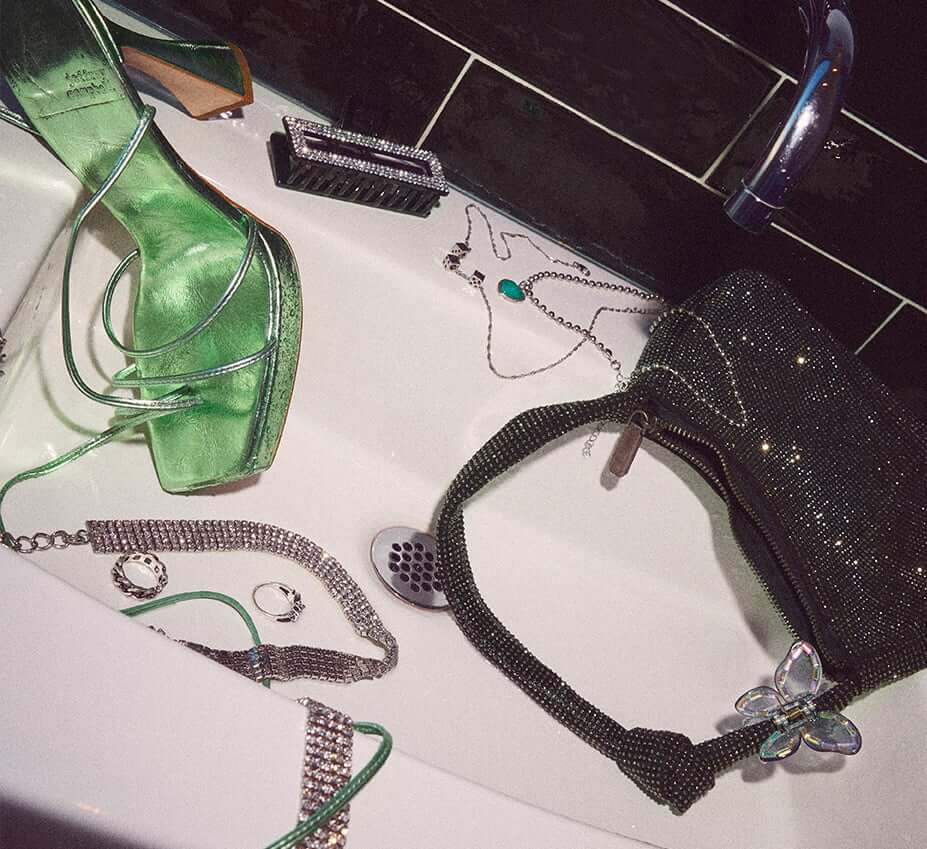 Model is wearing a white puffer and white tank top.