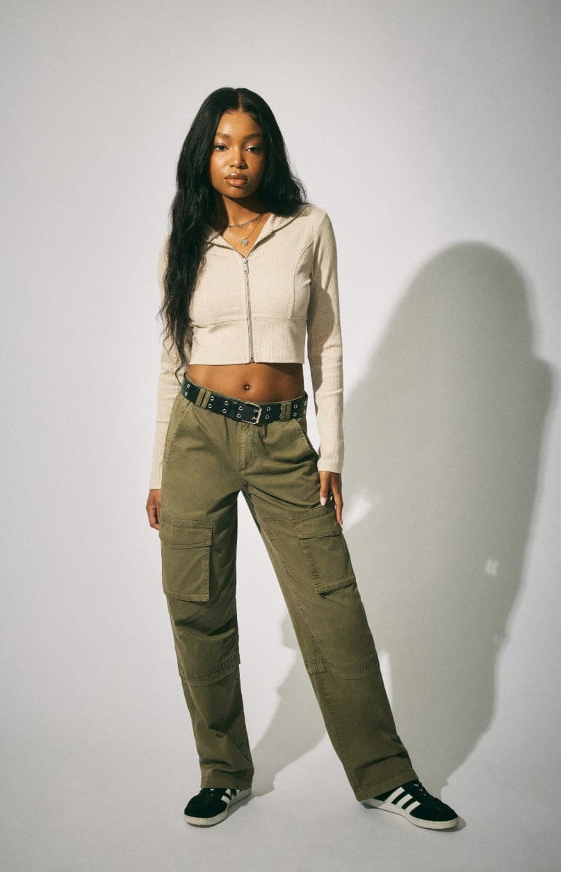 Model wears a hoodie and khaki cargos.