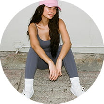 Model is wearing grey jumpsuit.