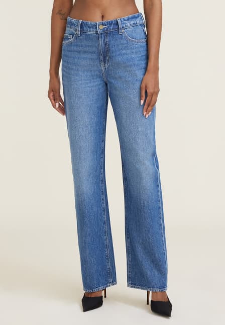 Model is wearing medium blue relaxed straight leg jeans.