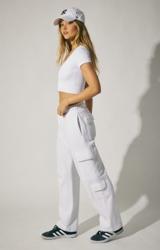 Model is wearing a white tshirt and white cargo with a white cap. 