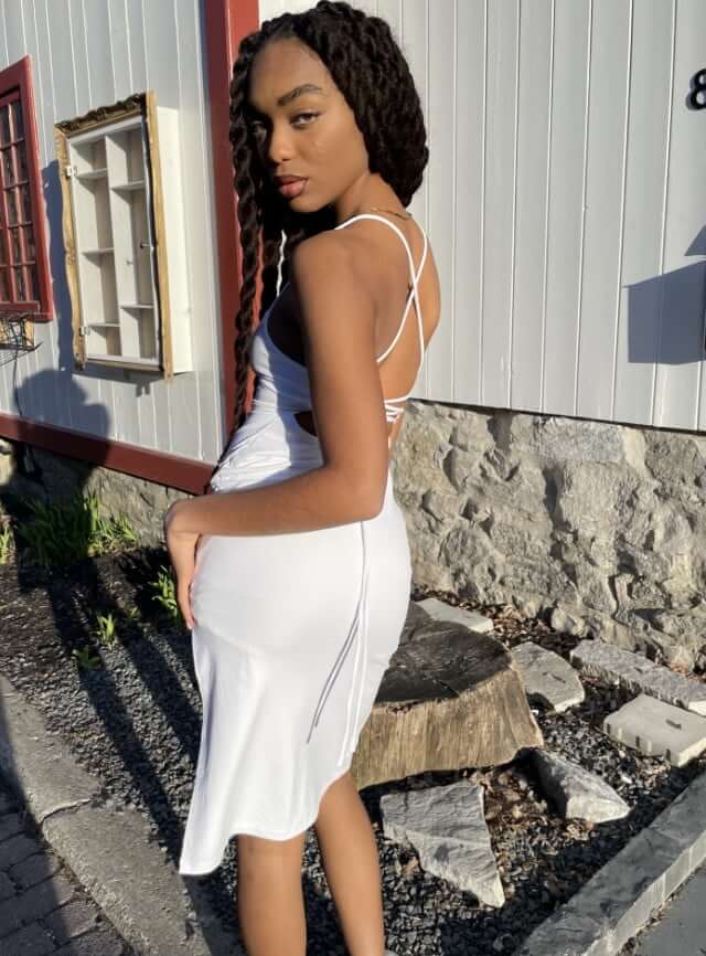 Model wearing a white dress.