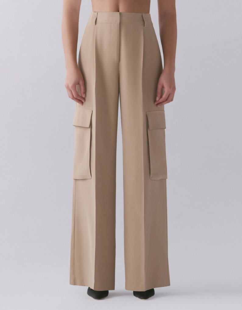 A model wears beige wide leg cargo pants.