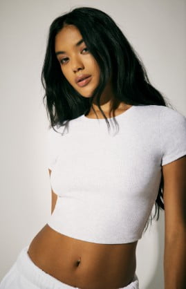 Model is wearing a white t-shirt and fleece bottoms.