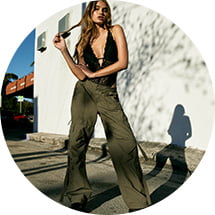 Model is wearing cargos and black top.