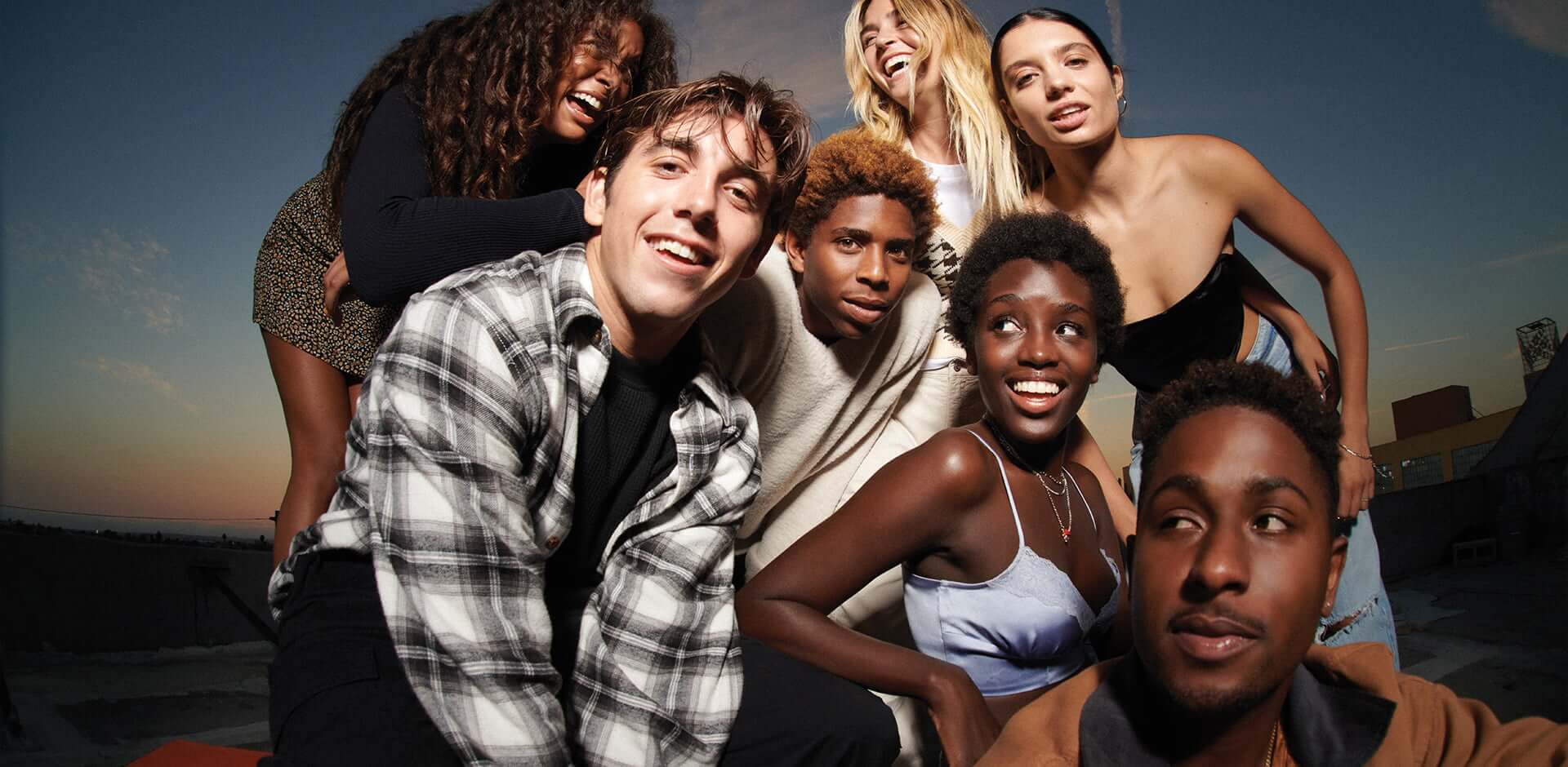 The skateboarding crew Illegal Civ as well as Tavia, Sparkle, Crystal, and Ganna pose on a rooftop for the Garage Fall 2021 campaign.