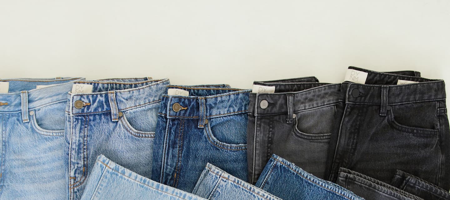 Folded jeans from light wash to dark wash and black.