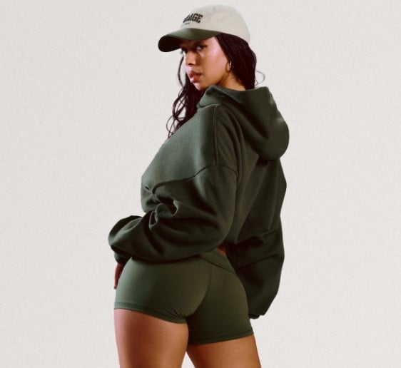 Model wears a light blue hoodie and matching sweats.