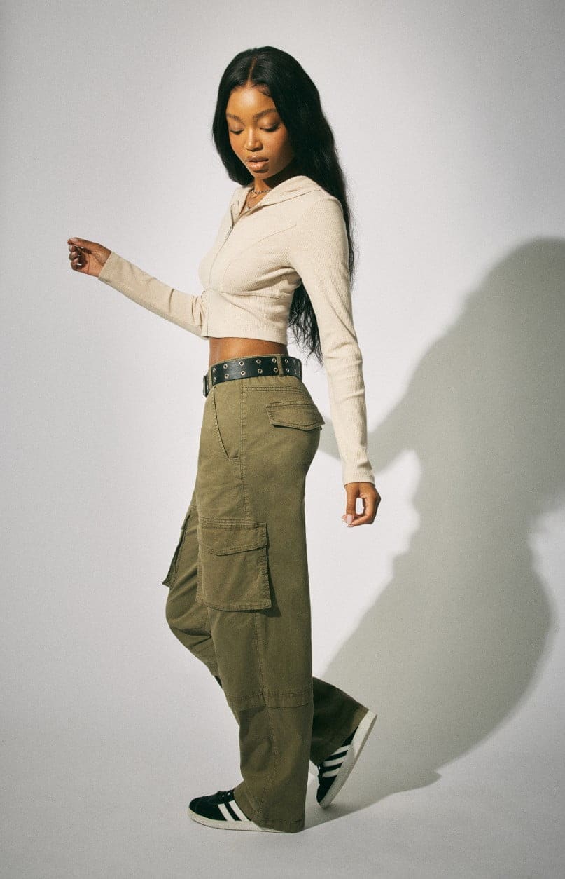 Model wears a hoodie and khaki cargos.