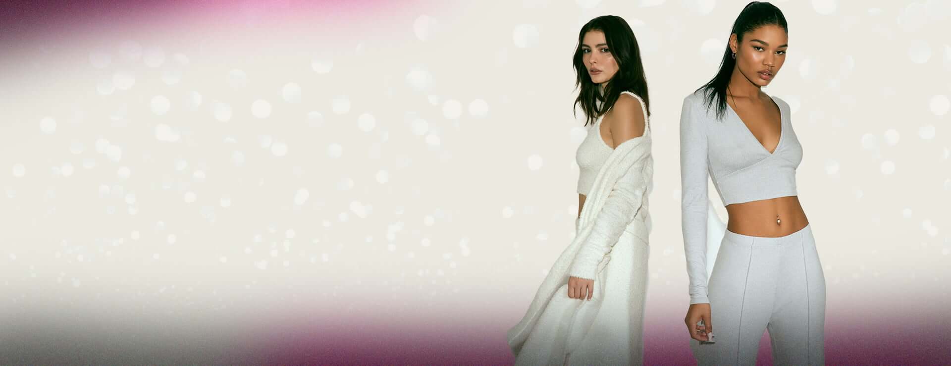 Model on the left is wearing a plush white lounge set and model on the right a grey cotton set.
