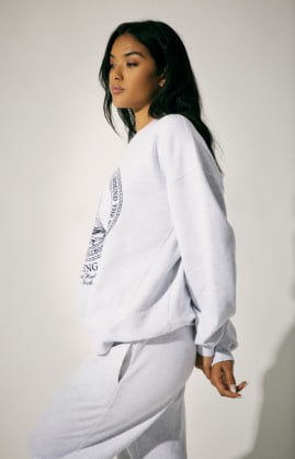 Model is wearing a grey sweat set.