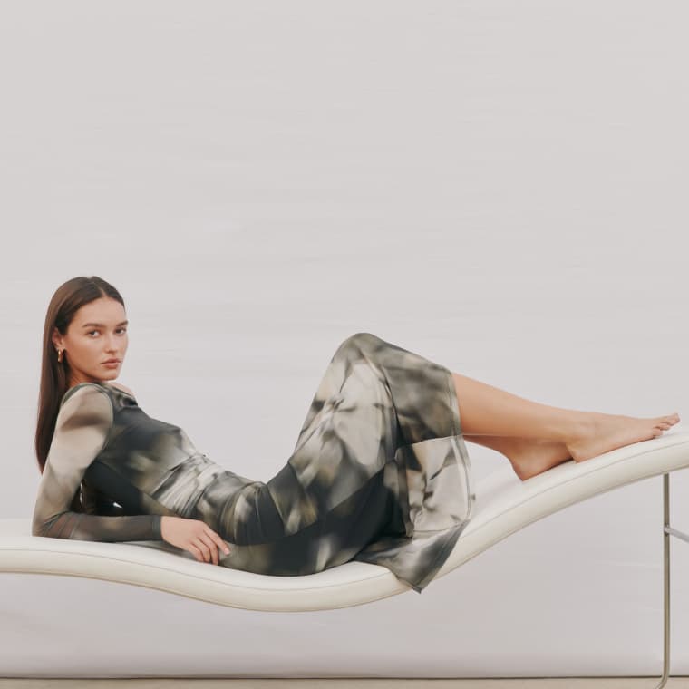 Model is wearing a longsleeve midi dress.