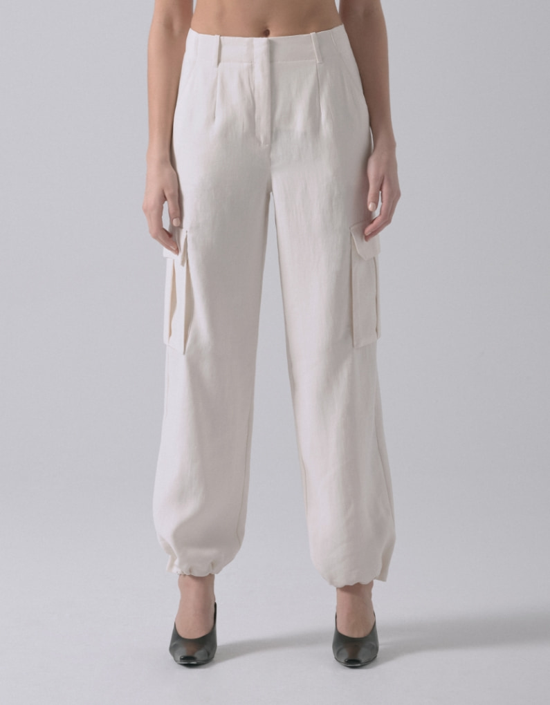 A model wears white cargo parachute pants.