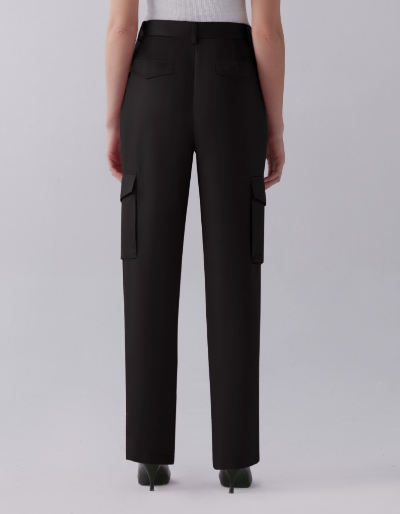 A model wears black satin straight leg pants. - back view.
